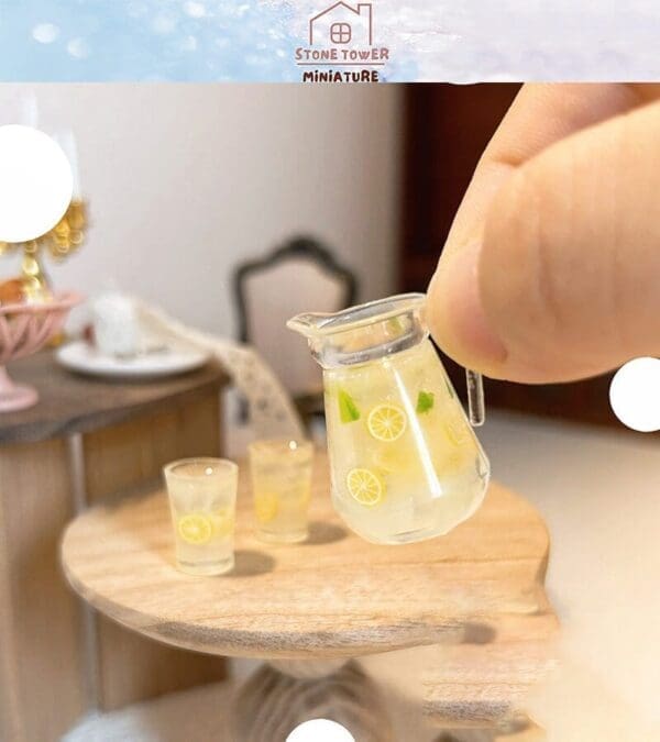 Miniature pitcher and glasses with lemon slices on a wooden table in a dollhouse dining room setting.