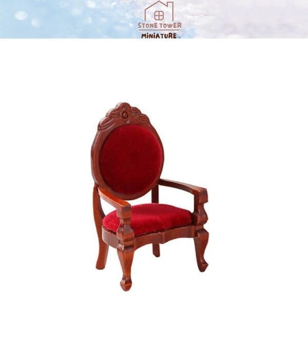 Miniature wooden armchair with red velvet cushion and backrest, decorative carved details, against a plain background.