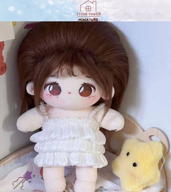 Cute plush doll with long brown hair in a white ruffled dress, standing with a small yellow plush toy.