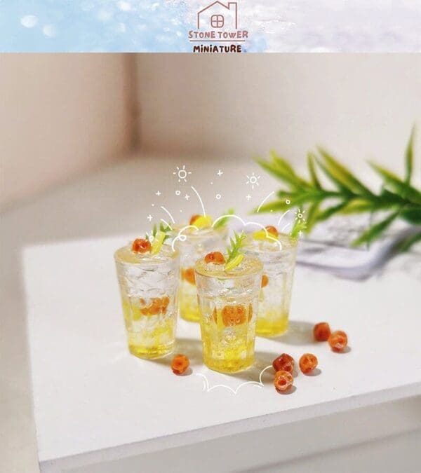 Miniature citrus-themed drinks with fruit garnishes on a white surface, surrounded by greenery accents.