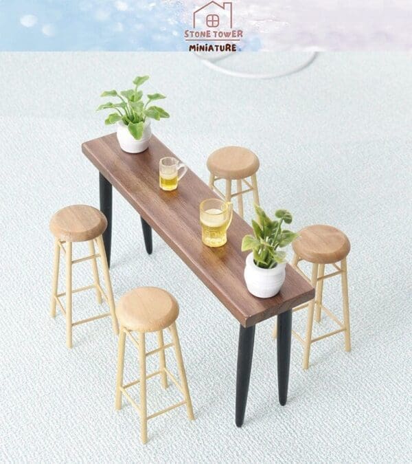 Miniature wooden table with five stools, two plants, and two mugs on a light textured surface.