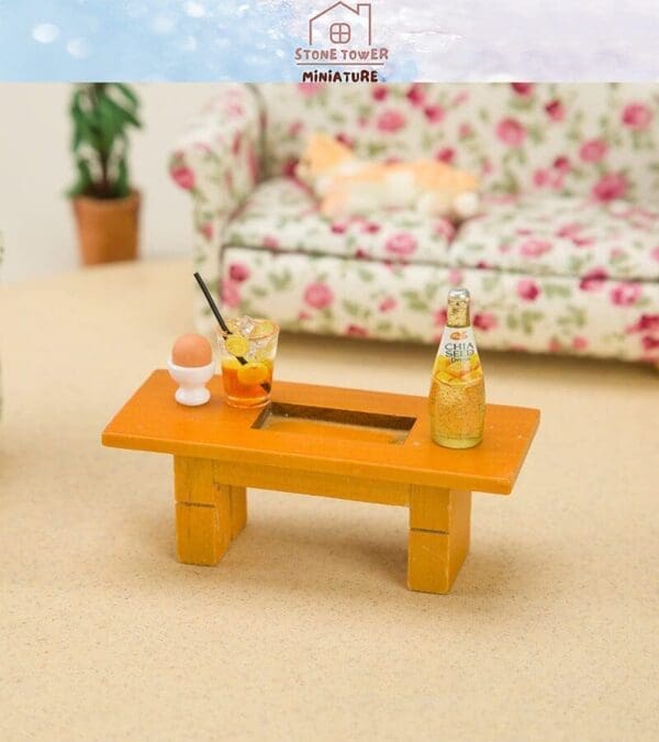 Miniature coffee table with drinks, an egg, and a floral couch in the background.