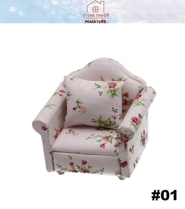 Miniature floral armchair with matching cushion on a white background.