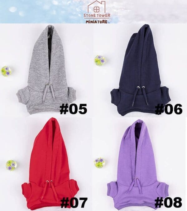 Four miniature hoodies in grey, navy, red, and purple, labeled #05 to #08, with floral balls nearby.