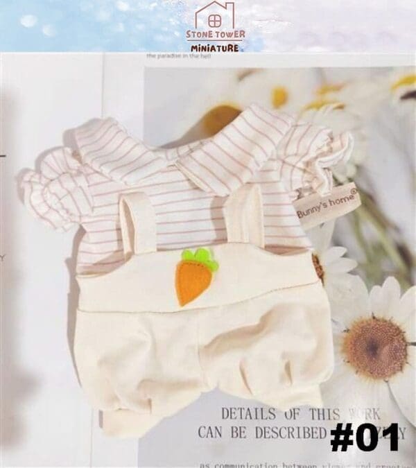 Striped doll outfit with ruffled sleeves and carrot detail on suspenders, displayed on a magazine page.