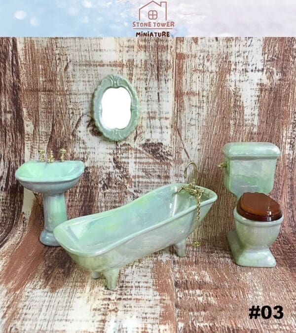 Miniature green bathroom set with sink, clawfoot tub, toilet, and mirror on a wooden background.