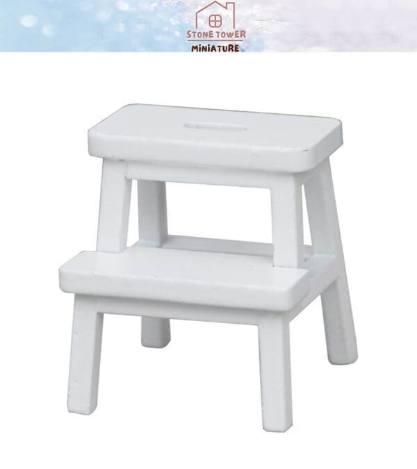 White miniature two-step stool with a simple design on a white background.