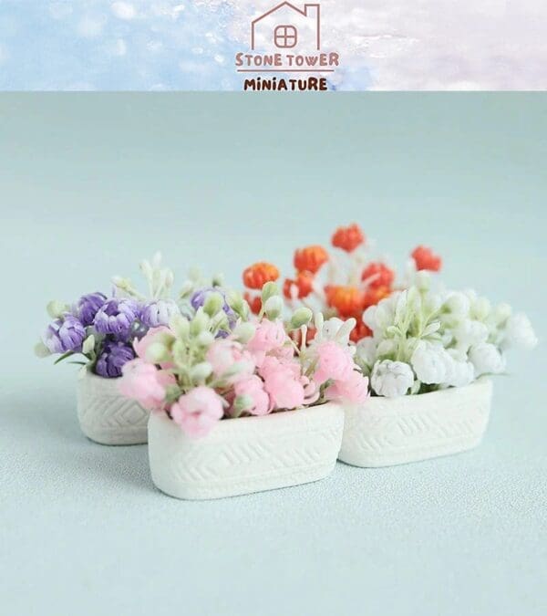 Miniature flower arrangements in white pottery, featuring purple, pink, orange, and white blooms, on a light background.