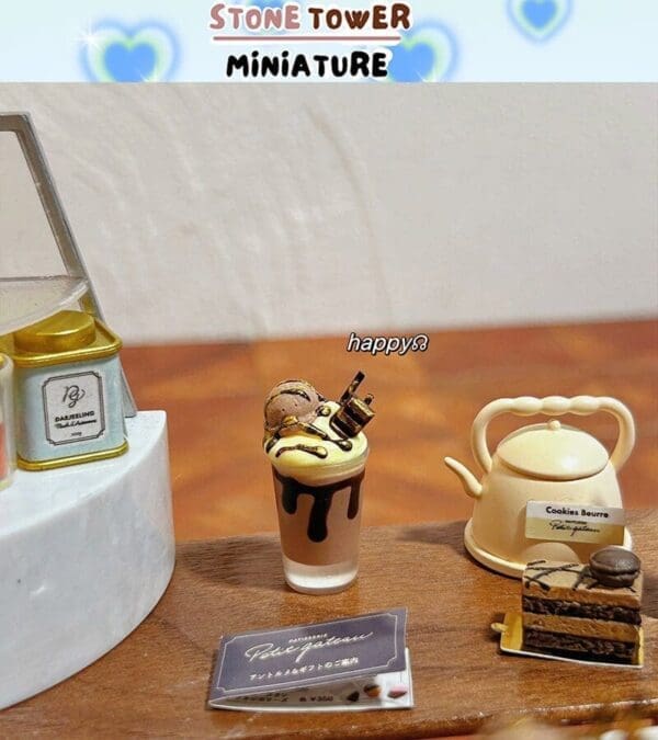 Miniature tea set with a dessert glass, kettle, and cake slice, labeled "ST0NE TOWER MINIATURE" and "happy8.