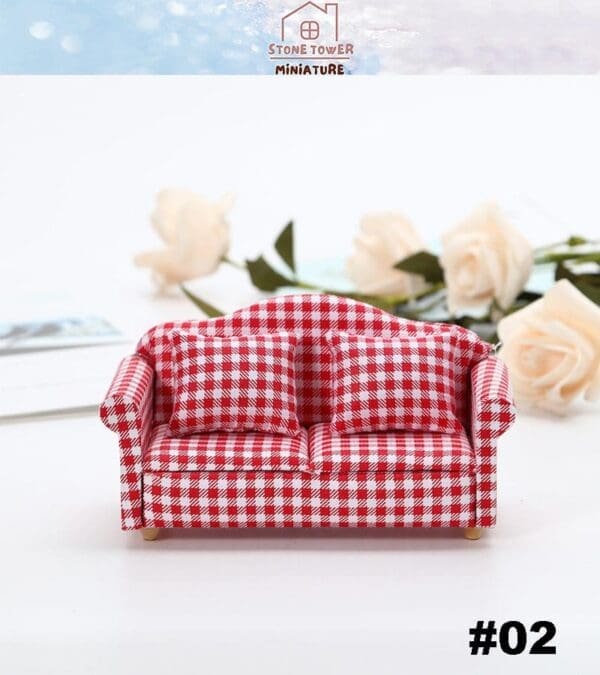 Red gingham checkered miniature sofa with white roses and a logo in the background.