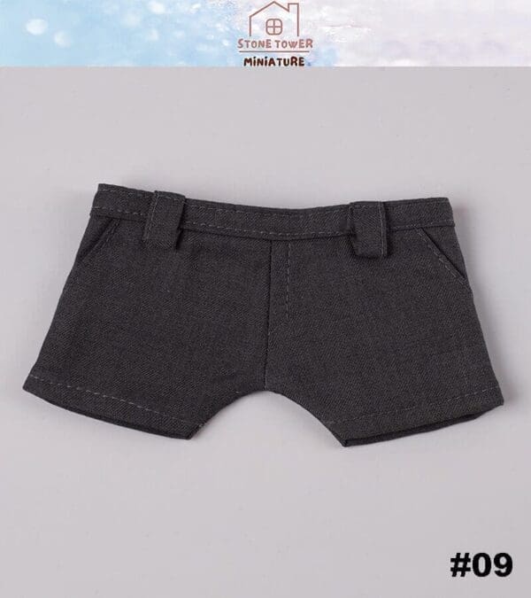 Dark gray miniature shorts on a gray background. Upper branding reads "Stone Tower Miniature." Bottom corner label: #09.