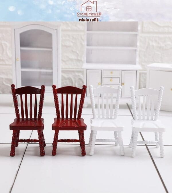 Two red and two white miniature chairs placed in front of white furniture backdrop.