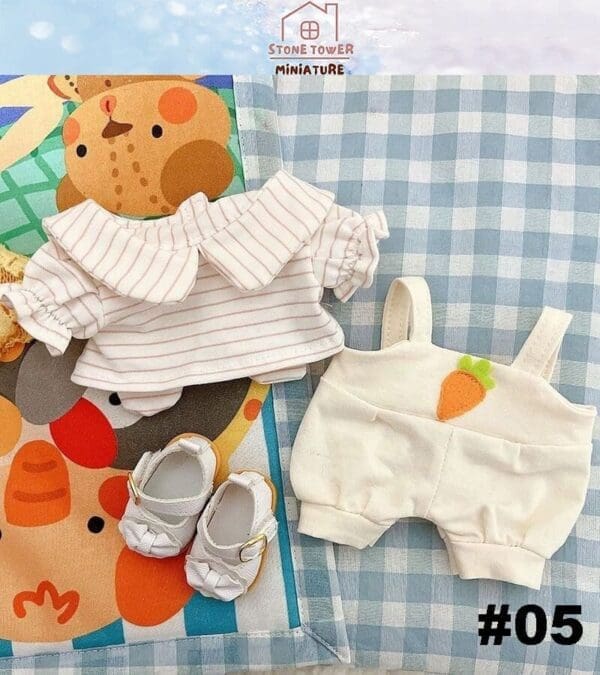 Miniature doll clothes set with striped top, carrot romper, and white shoes on a blue checkered fabric. #05