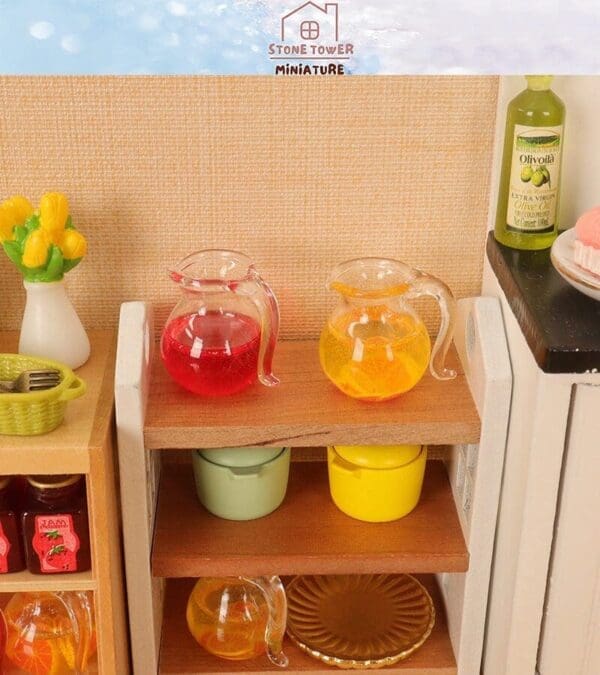 Miniature kitchen setup with colorful juice pitchers, cooking pots, jam jars, and a vase of yellow flowers on wooden shelves.