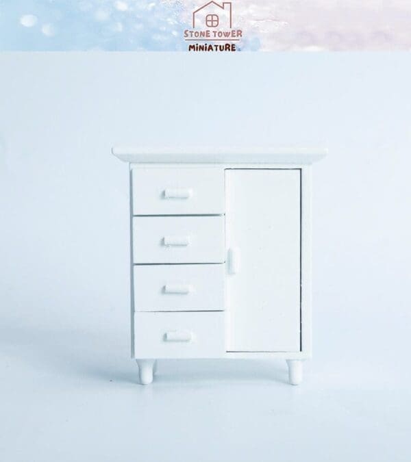 White miniature cabinet with four drawers and one door against a light background.