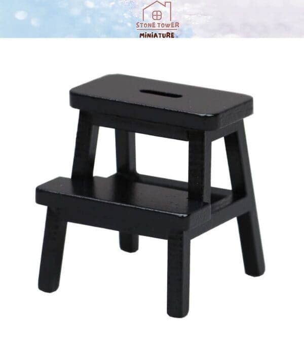 Black miniature wooden step stool with two steps, displayed against a white background.