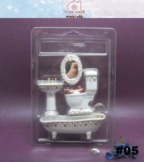 Miniature porcelain bathroom set with a sink, toilet, bathtub, and mirror in a clear package, labeled #05.