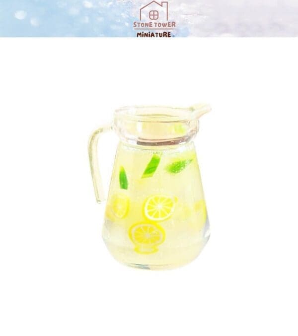 Miniature glass pitcher with lemon slices and leaves inside, against a white background.