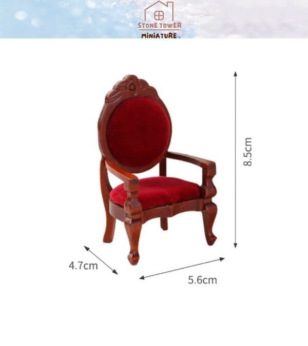 Miniature wooden chair with red velvet upholstery, measuring 8.5cm high, 5.6cm wide, and 4.7cm deep.