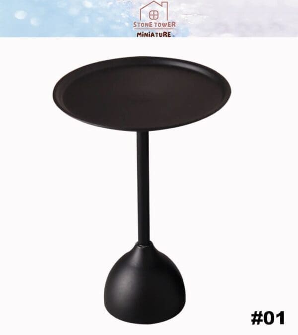 Black miniature round table with a flat top and a pedestal base.