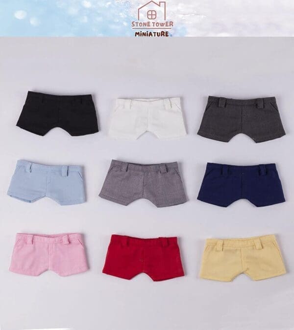 Nine pairs of miniature shorts in various colors are displayed on a light background.