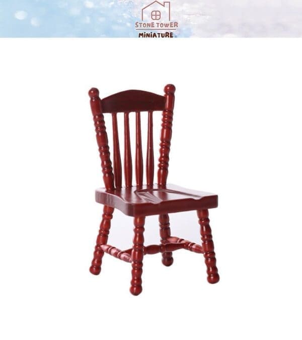 Red wooden miniature chair with spindle backrest and turned legs, displayed against a white background.