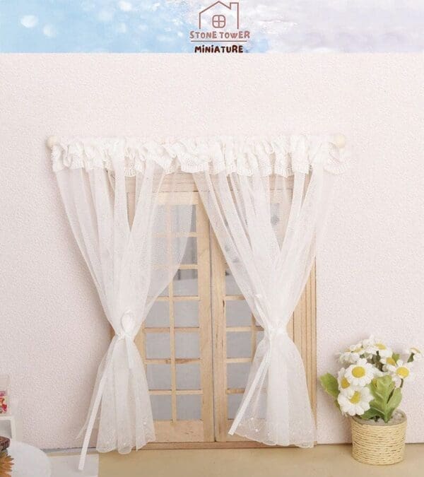 Miniature wooden window with sheer white curtains and a small vase of daisies on the side.