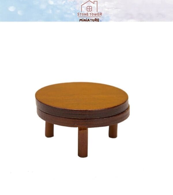 Miniature round wooden table with four legs against a white background.