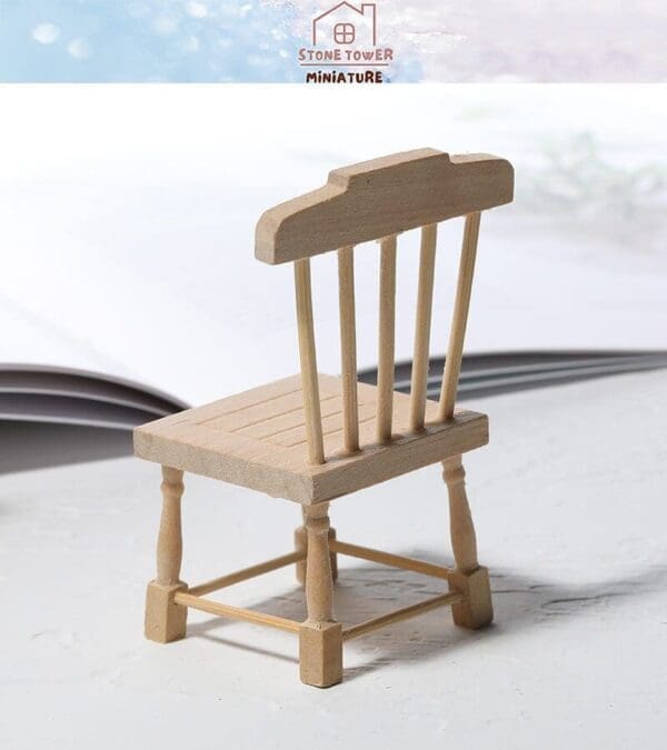 Miniature wooden chair with spindle backrest on a light surface, blurred background, "Stone Tower Miniature" text above.