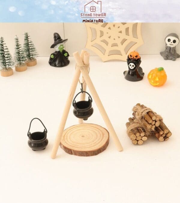 Miniature Halloween scene with cauldron, witches, spiders, pumpkins, and tiny trees on a white background.