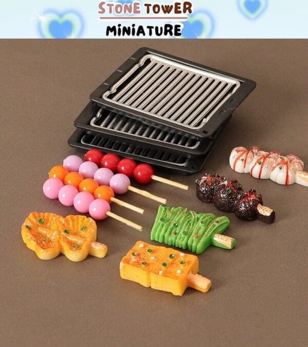 Miniature food models with colorful skewers and tiny grills on a brown surface.