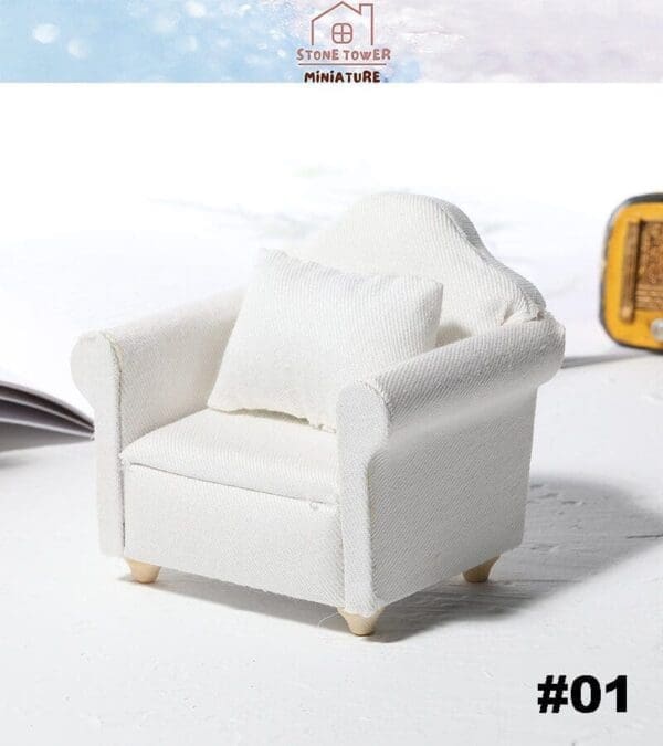 White miniature armchair with pillow on a light background, labeled #01, Stone Tower Miniature logo above.