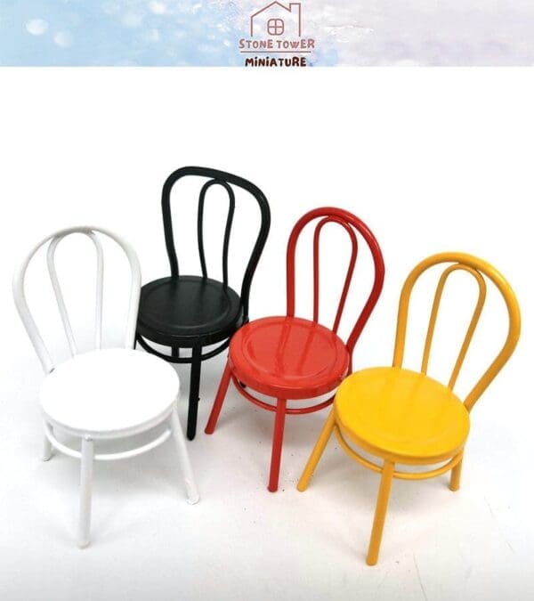 Four miniature colored chairs: white, black, red, and yellow, arranged on a white surface.