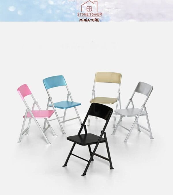 Colorful miniature folding chairs in pink, blue, beige, silver, and black arranged on a white background.