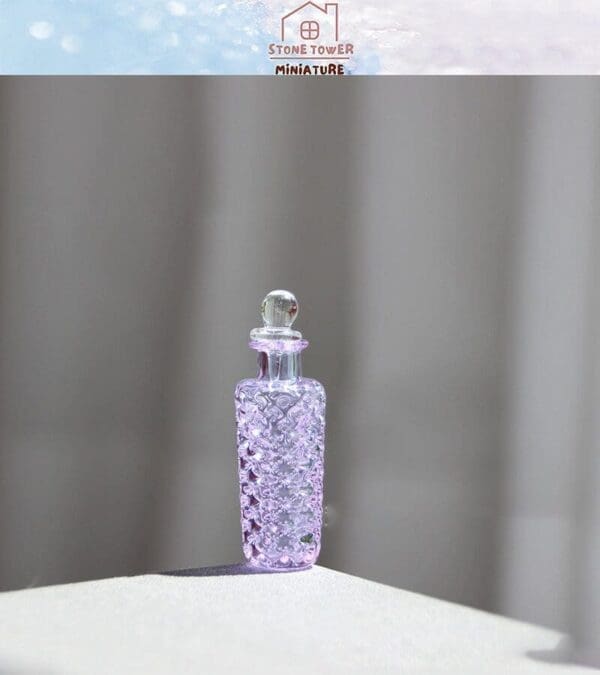 Purple glass bottle with textured surface on a light background, labeled "Stone Tower Miniature" above.