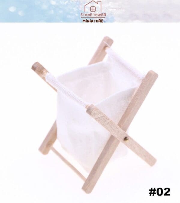 Miniature wooden laundry basket with a white cloth bag, labeled "#02," by Stone Tower Miniature.