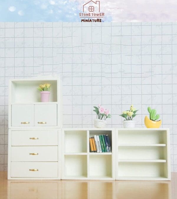 Miniature white shelves with books and potted plants against a tiled wall, labeled "Stone Tower Miniature.