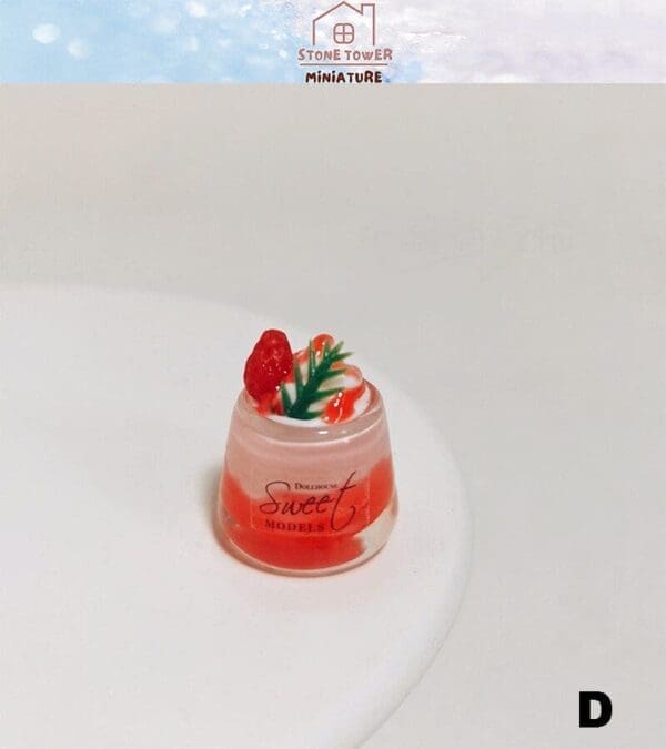 Miniature dessert in a clear cup with strawberry and cream garnish, labeled "Sweet Models.