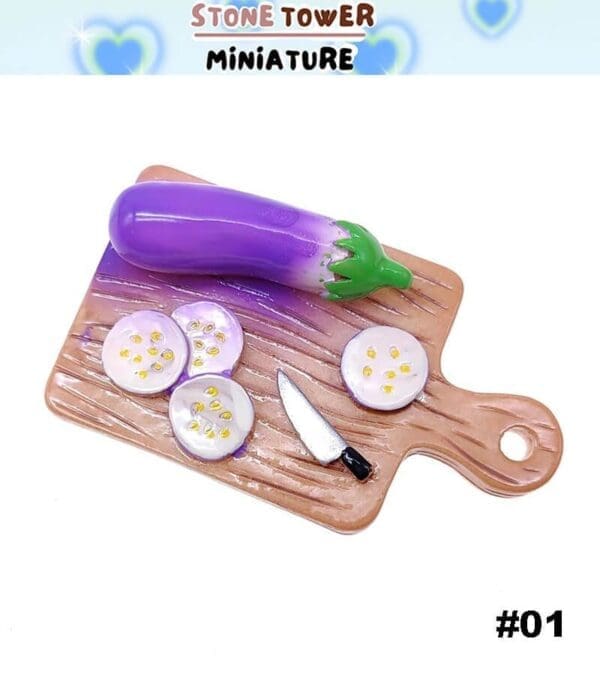 Miniature eggplant and slices on a cutting board with a tiny knife set on a white background.