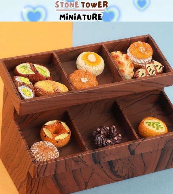 Miniature bread replicas in a wooden display box, featuring diverse styles like rolls and pastries.