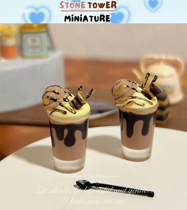 Miniature chocolate desserts with ice cream and drizzle, topped with cookies and sticks, on a white plate.