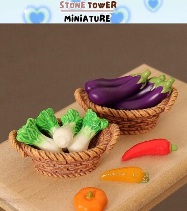 Miniature vegetables in baskets, featuring eggplants and bok choy, with small peppers on a wooden surface.