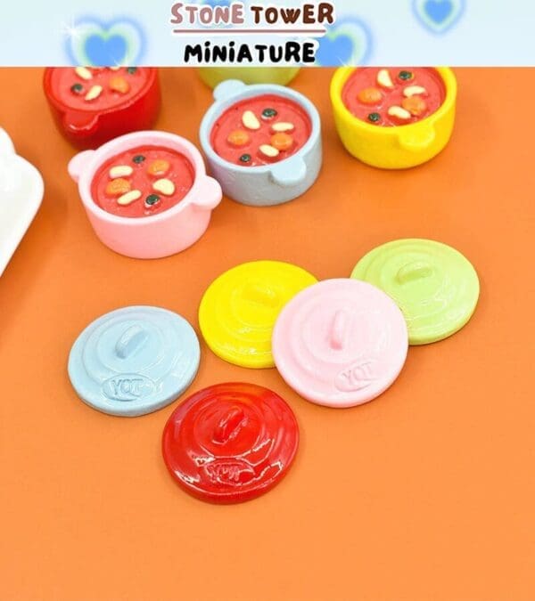 Colorful miniature pots with lids on an orange surface, featuring vibrant stews inside.