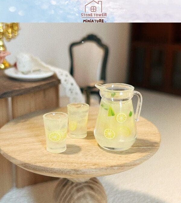 Miniature pitcher and glasses of lemonade with lemon slices on a small wooden table.