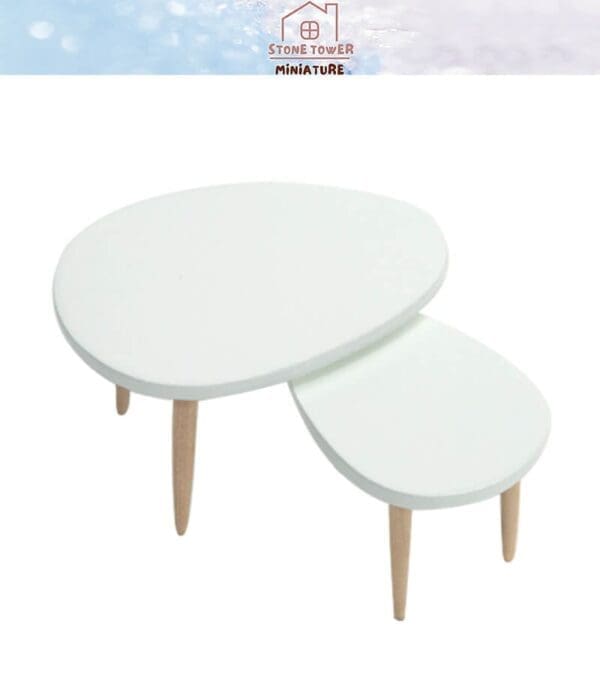 Two-tier white round coffee table with wooden legs on a light background.