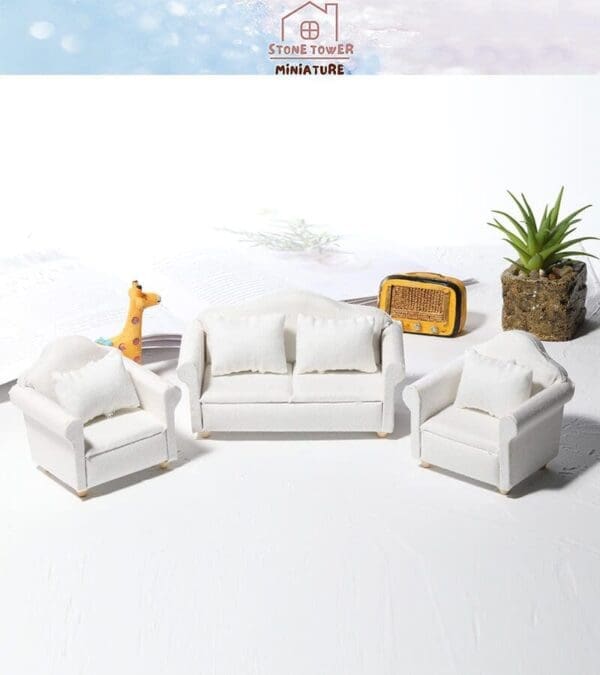 Miniature white sofa set with a potted plant, giraffe figure, and radio on a light background.