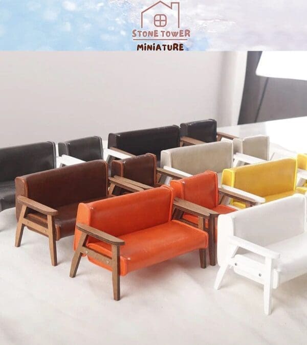 Miniature colorful sofas arranged on a table with wooden armrests, featuring the Stone Tower Miniature logo above.