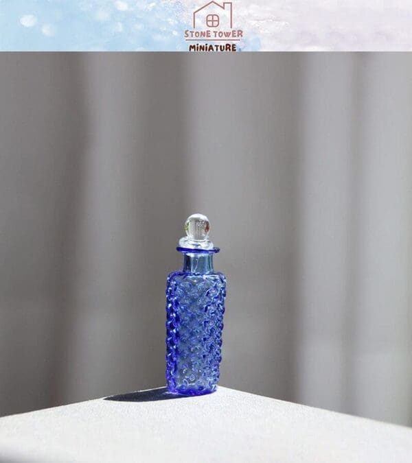 Blue textured glass bottle with stopper standing on a light surface, casting a shadow.