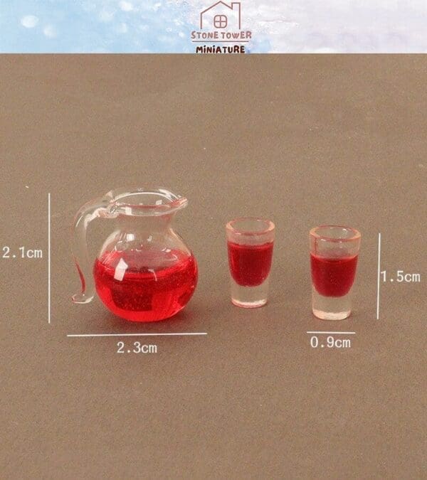 Miniature clear pitcher and two shot glasses with red liquid, showing dimensions: pitcher 2.1x2.3cm, glasses 1.5x0.9cm.