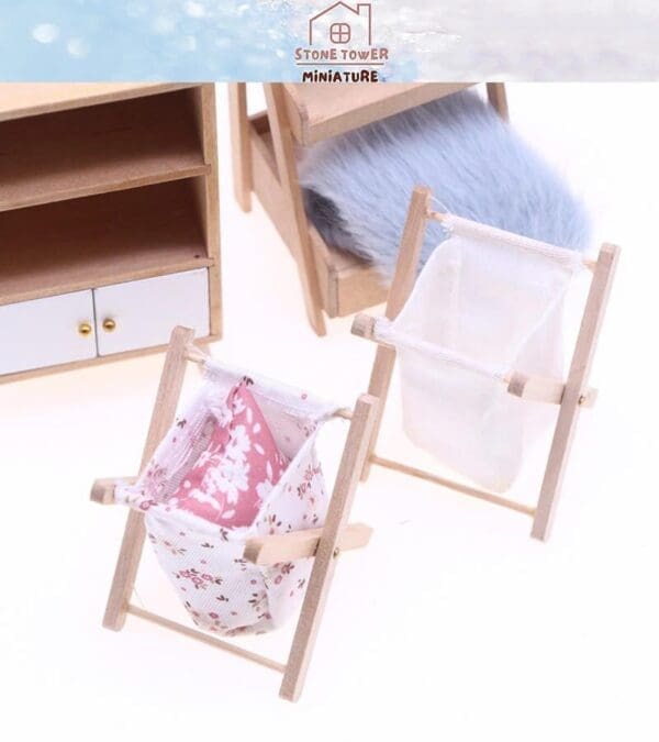 Miniature laundry rack with clothespins and fabric, beside a small wooden shelf and furry chair in background.